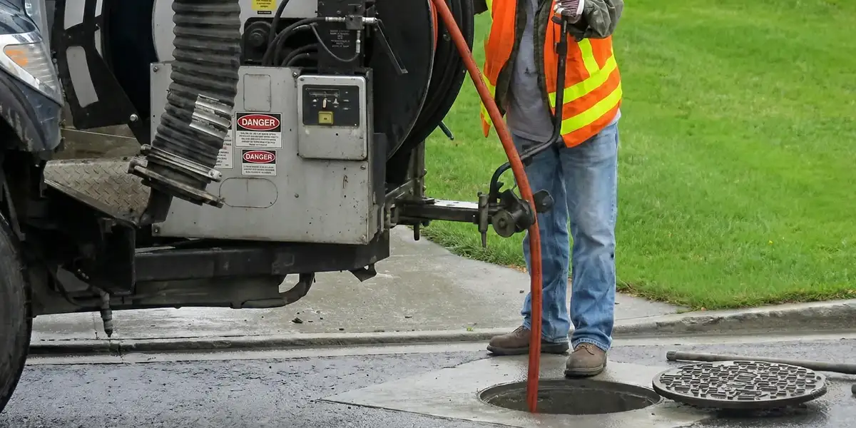 sewage clean up professionals using industrial equipment to remove contaminated wastewater in Cambridge, MA