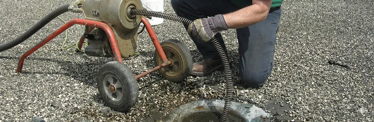sewer rodding technician actively removing blockages from a sewer line in Cambridge, MA