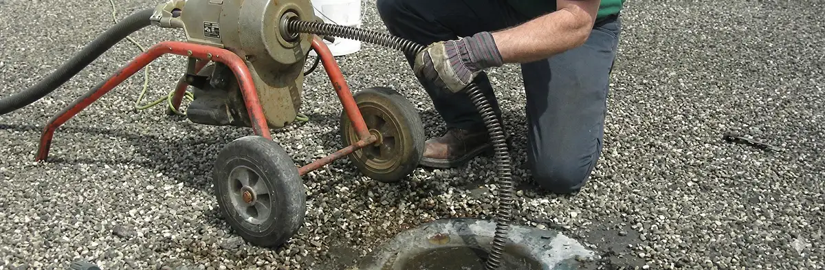 sewer rodding technician actively removing blockages from a sewer line in Cambridge, MA