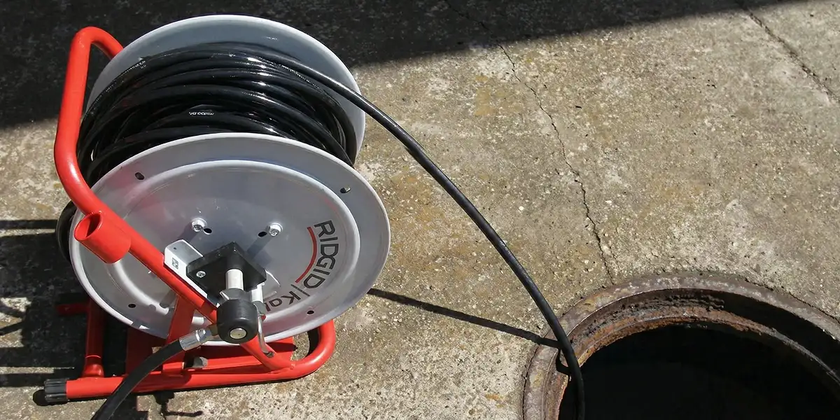 sewer rodding equipment prepared to clear clogged sewer lines in Cambridge, MA